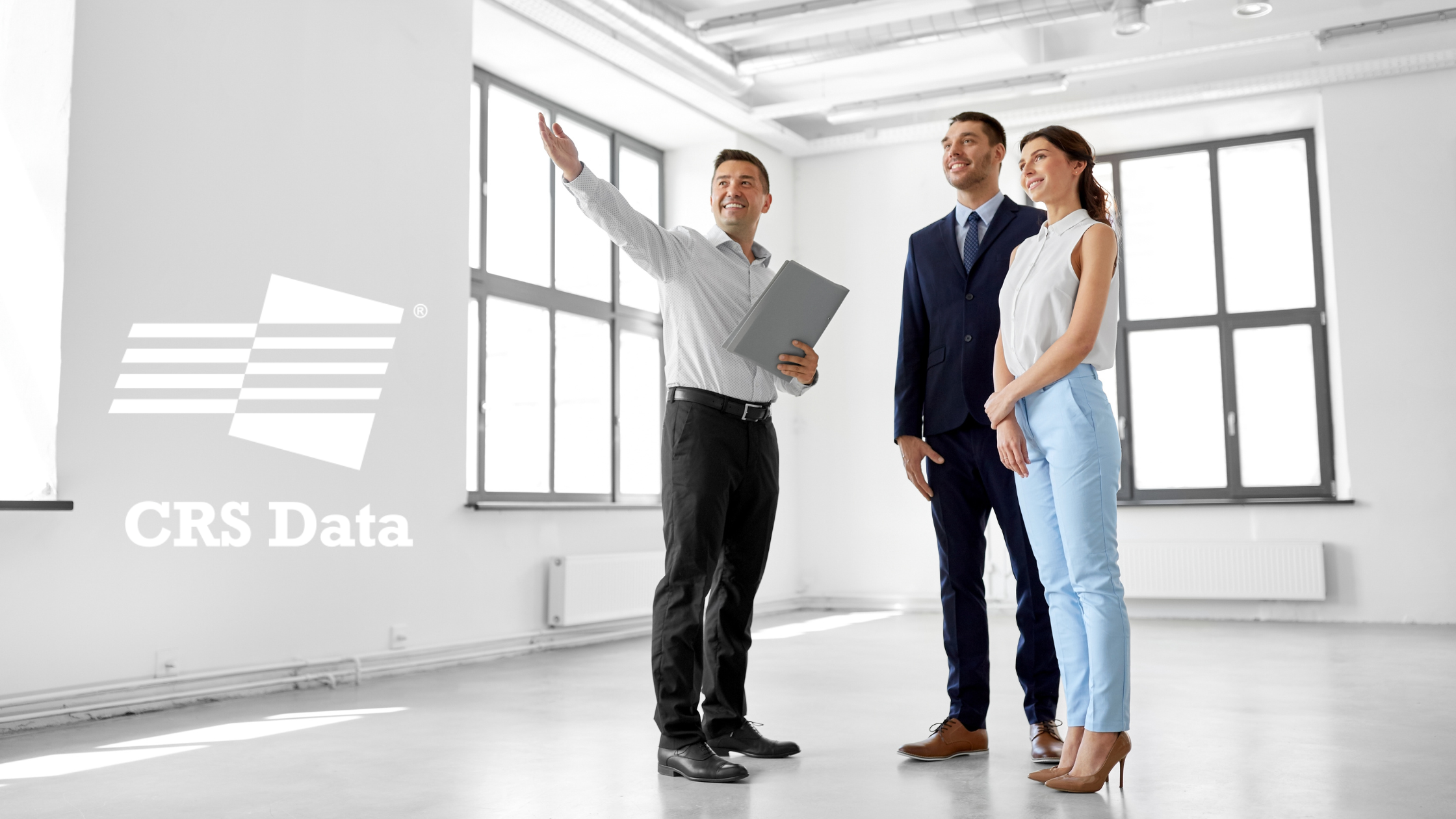 Image of real estate agent showing a couple a home with the CRS Data Logo